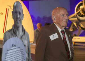 Ron Hermanns next to a display panel of himself at the New Zealand Air Force Museum 2019 (TVNZ)