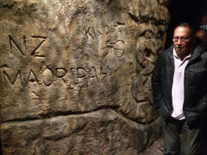 A visitor next to the three dimensional carved wall at Te Papa, Wellington