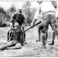 Japanese soldiers bayoneting Chinese prisoner
