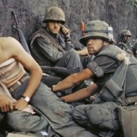 A corpsman treats a wounded Marine, June 1968