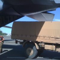 Army truck unloading supplies fromC130