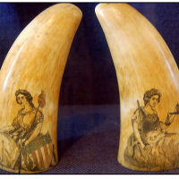 Scrimshaw on matching whale teeth