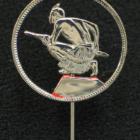 A Maori warrior holding a taiiaha spear from a shilling (twelve pence) coin (New Zealand Air Force Museum)