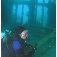 A diver serveys the wreck of the Kinugawa Maru
